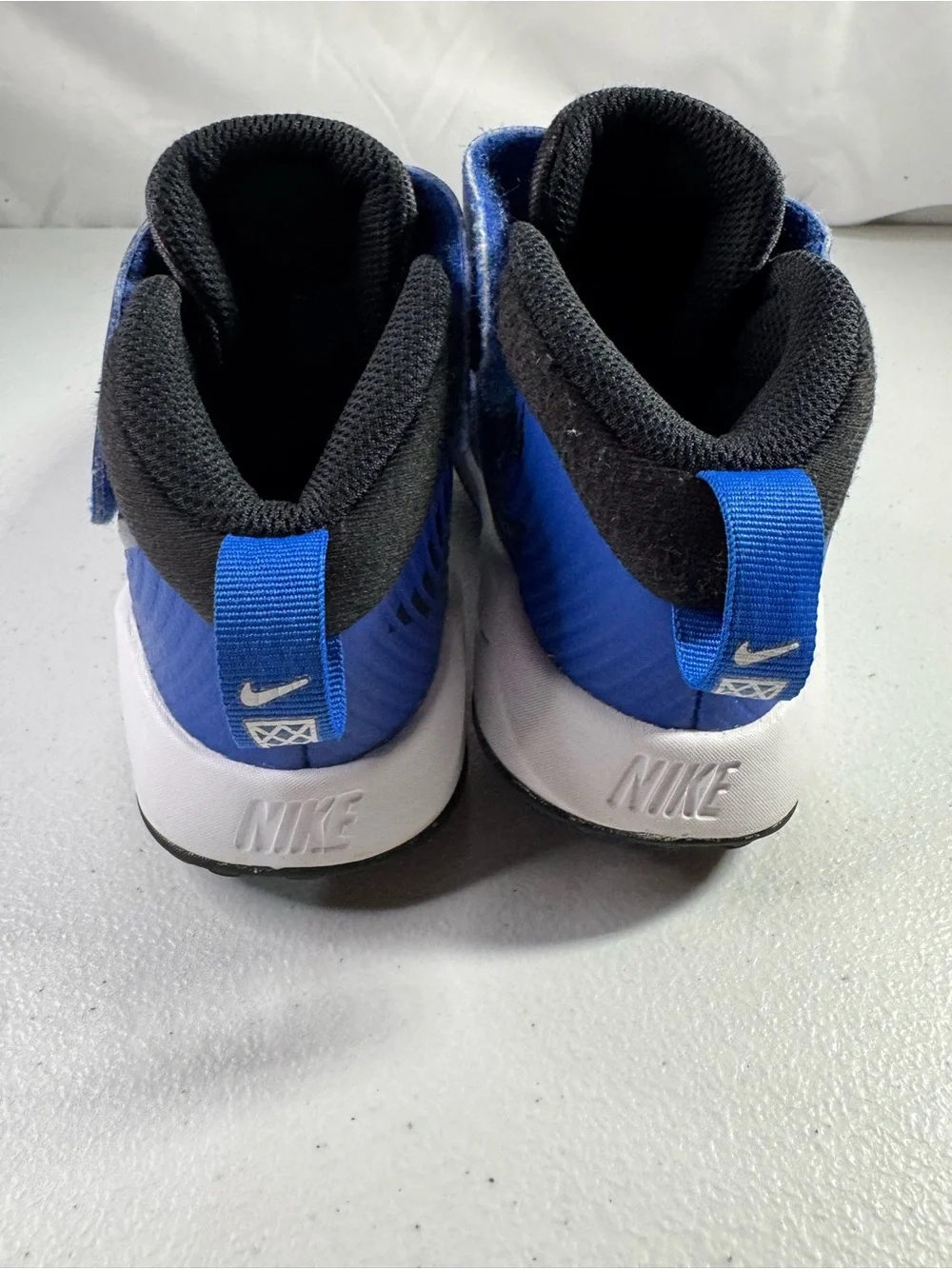 Nike Team Hustle Kids' High-Top Sneakers in Royal Blue and Black